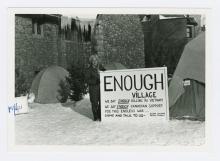 Claire Culhane with 'Enough Village' sign.