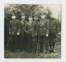 Soldiers standing, some with canes.