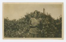 Black and white photograph of a woman outside.