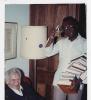 Photograph of Norman Mailer about to autograph books for Austin Clarke